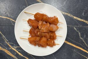 Put the chicken on the skewers